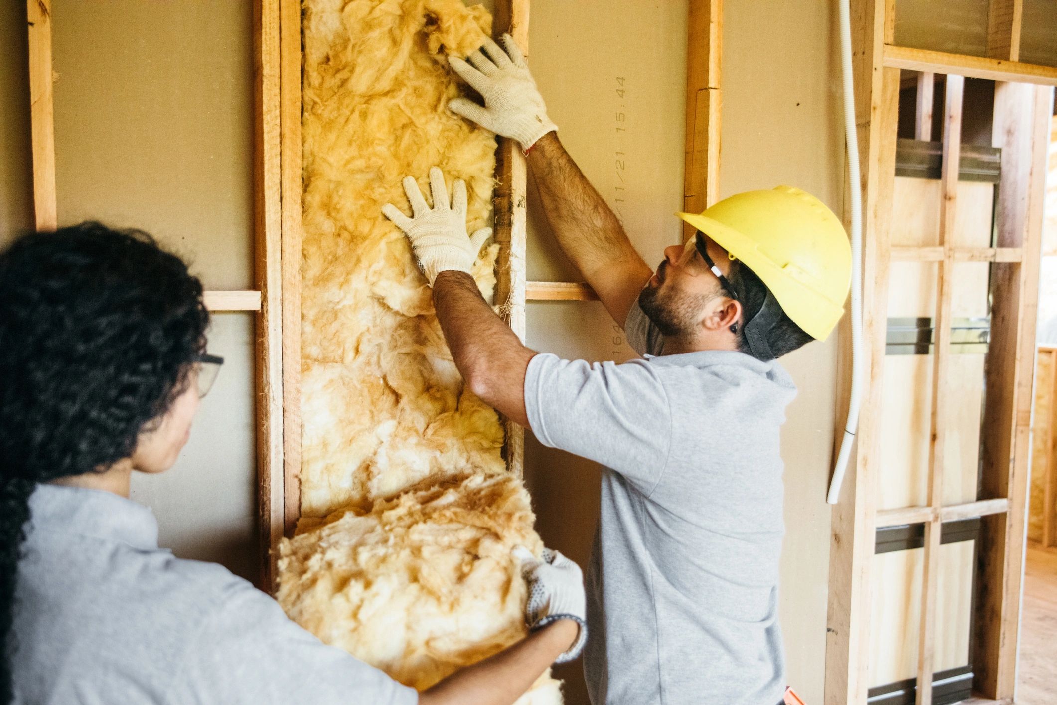 Construction team installing thermal insulation